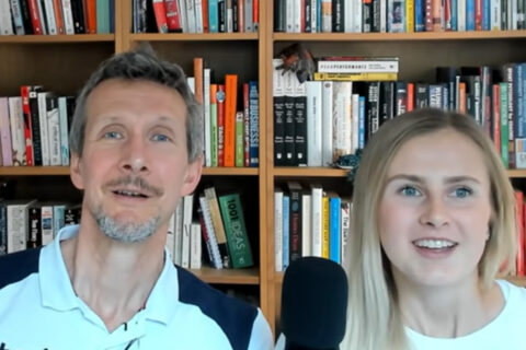 Stephen Seiler and his daughter Siren sit in front of a bookshelf