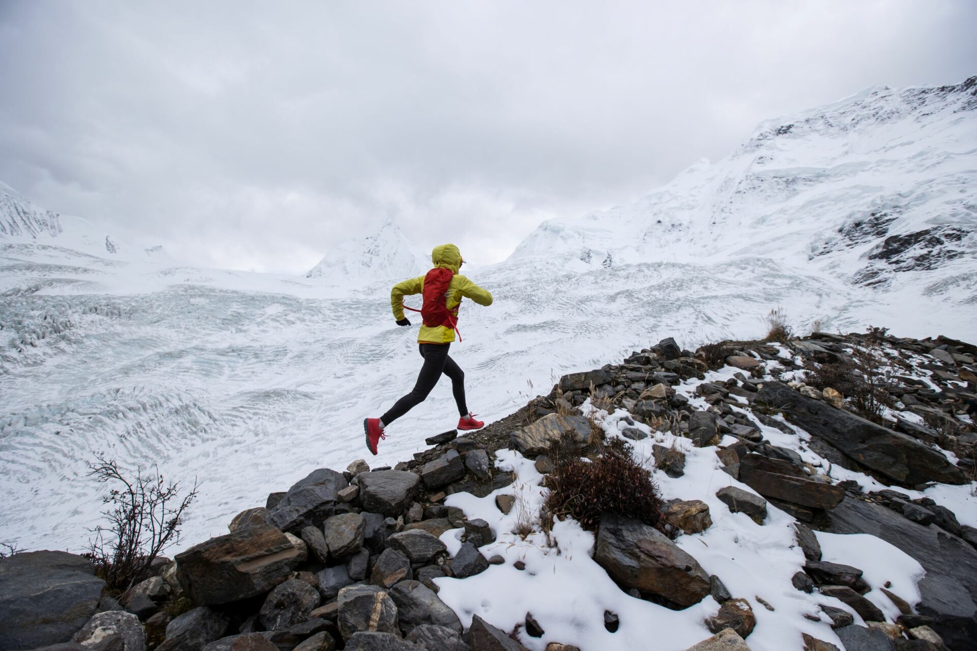 Person ultrarunning across a snowy mountain