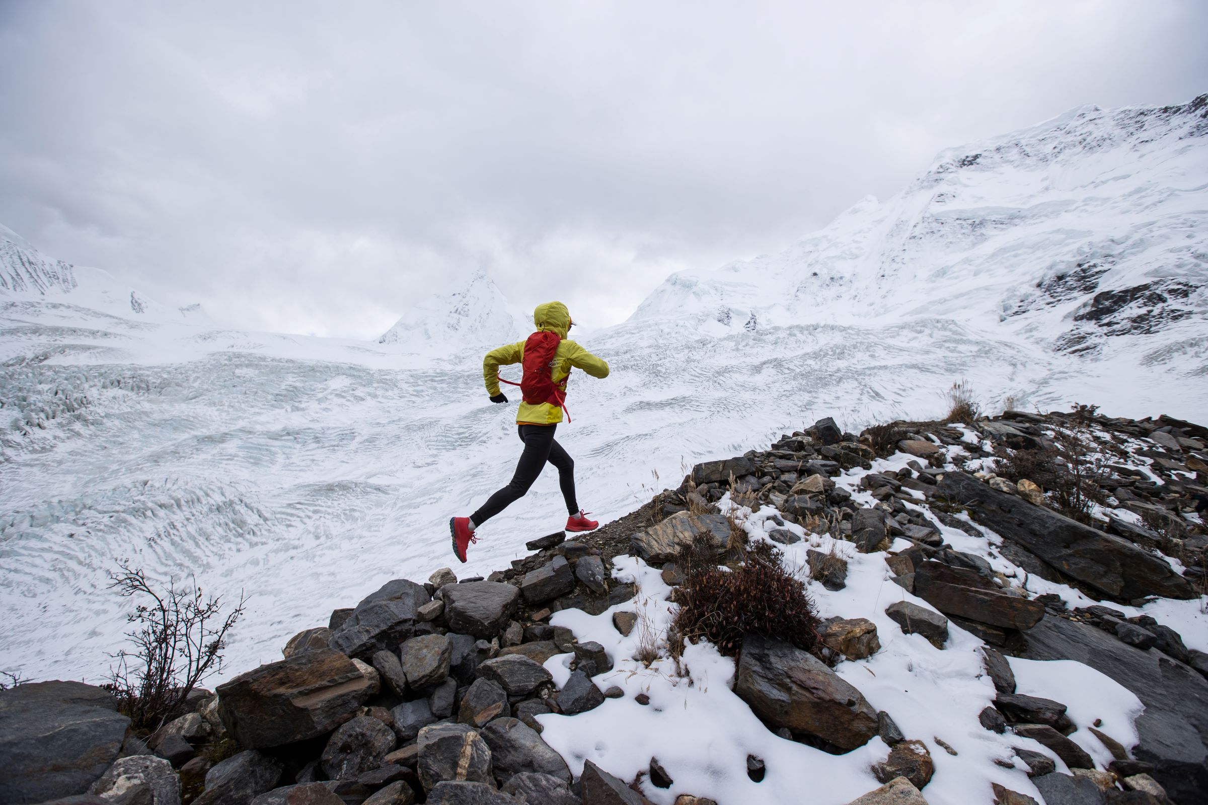 Person ultrarunning across a snowy mountain