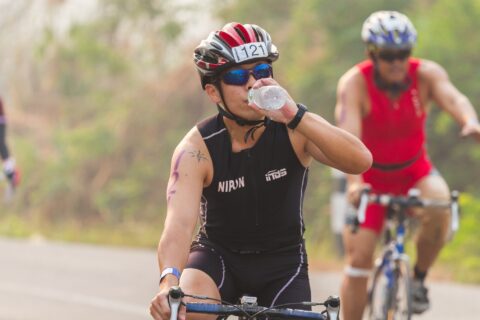 Triathlete drinking water during the bike leg of a race.