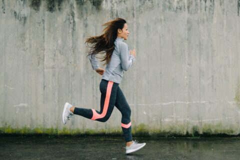 Woman in workout gear running.