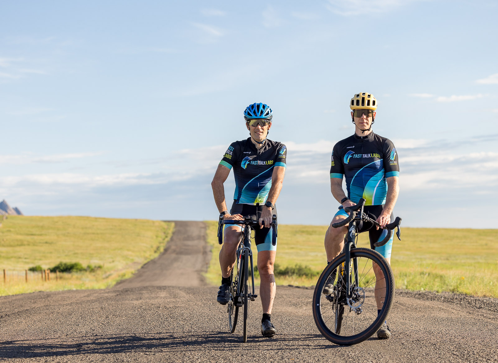 Trevor Connor and Rob Pickels standing above their bikes on a gravel road near the Flatirons in Boulder, Colorado.