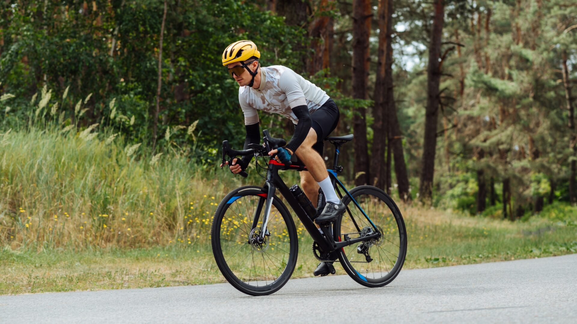 A man sprinting out of the saddle of his road bike